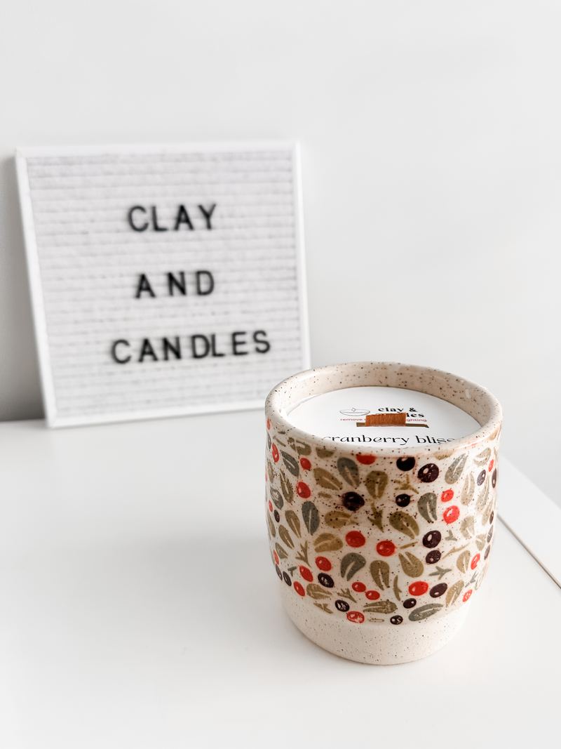 Ceramic candle with a red and green floral glaze