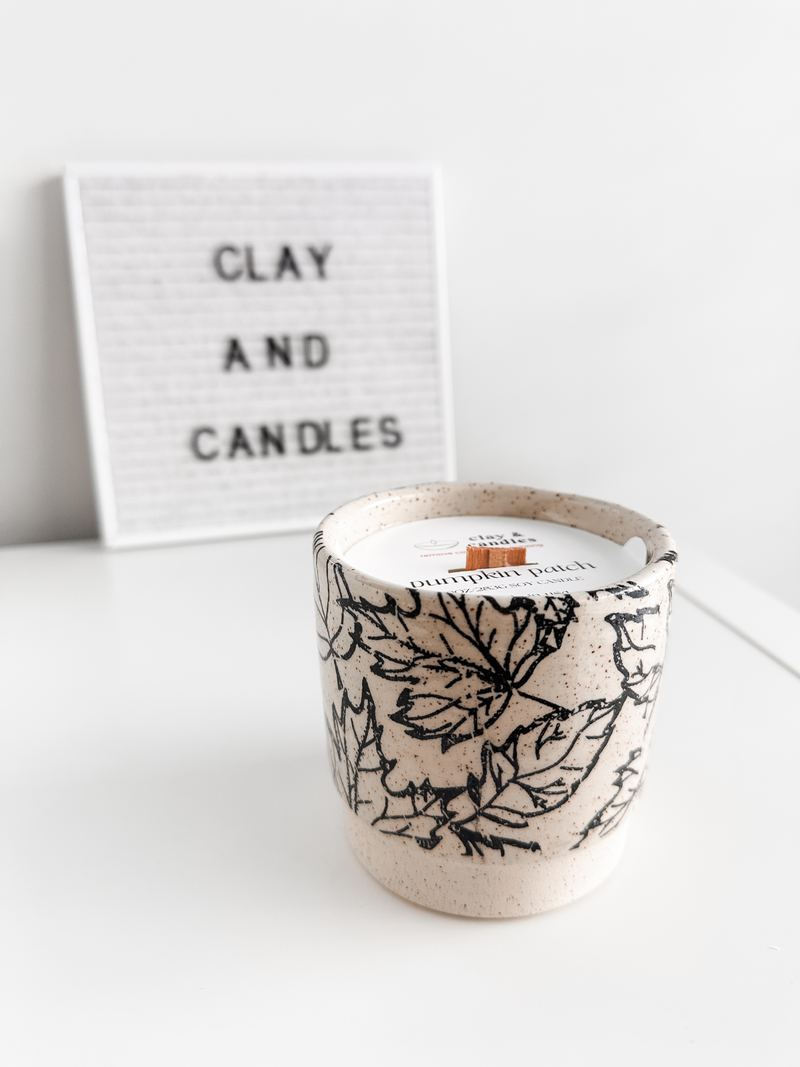 Ceramic candle cup covered in hand-drawn leaves
