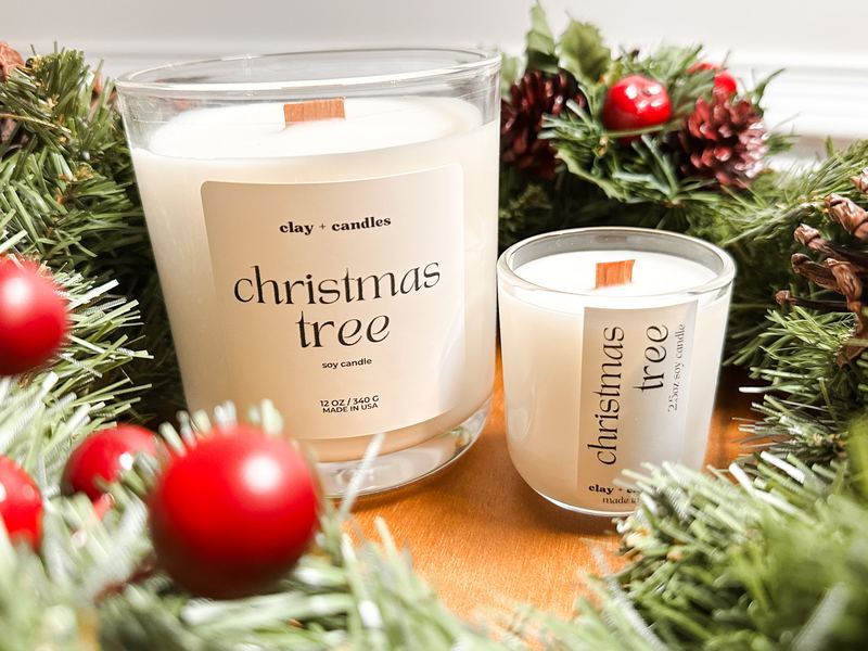 Christmas Tree candle in a cork-lid jar with pine garland and red berries