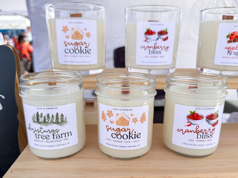 Sugar Cookie, Cranberry Bliss and Christmas Tree candles on a market shelf